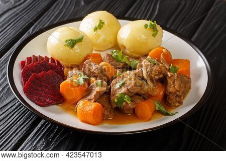 Delicious Slow Stewed Beef Kalops With Boiled Potatoes And Pickled Beets Close-up In A Plate On The 