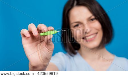 Beautiful Happy Young Woman Using Interdental Brush On Blue Background