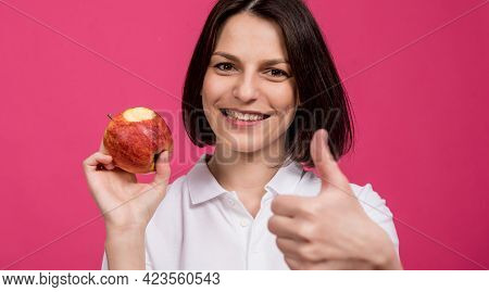 Beautiful Young Woman Hold A Big Apple In Her Hand