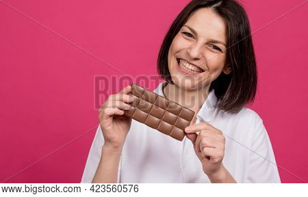 Beautiful Young Woman Holding A Bar Of Chocolate In Her Hand