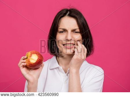 Beautiful Young Woman Bites A Big Apple And Has A Toothache