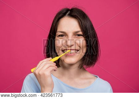 Beautiful Happy Young Woman With Single Tufted Toothbrush On Blank Pink Background
