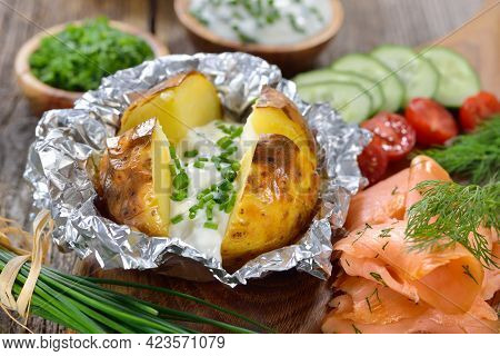 Baked Jacket Potato Fresh From The Oven Served With Chives Sour Cream And Smoked Salmon