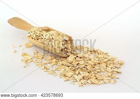Oat Flakes In Wooden Spoon Isolated On White Background. Heap Of Oats For Package Of Oatmeal Or Gran