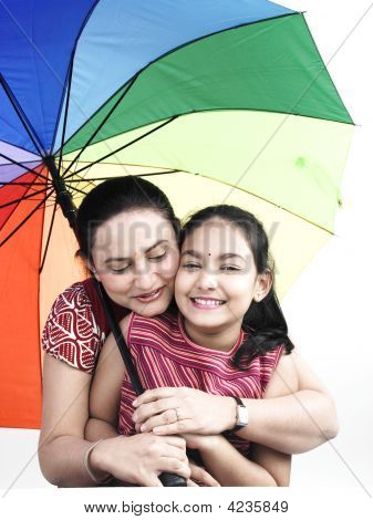 Mother And Daughter With One With Rainbow Umbrella