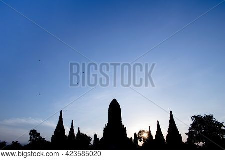 Silhouetted Image Of Chaiwatthanaram Temple In The Evening When The Sun Is About To Set.