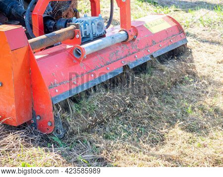 Close-up Of A Tractor With A Chain Mower Chopping Dry Grass. Maintenance Of The Territory, Mulching 