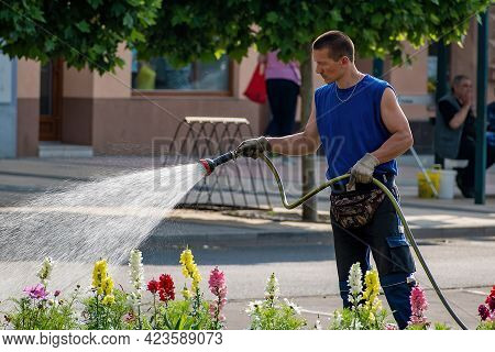 Hodonin, Czech Republic June 12, 2021 Man Watering Urban Greenery City Maintenance. Editorial Photo 