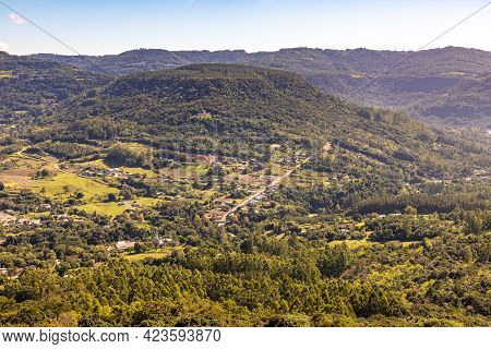 Countryside View With Forest, Mountains And Small Farms