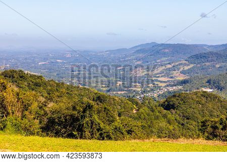 Countryside View With Forest, Mountains And Small Farms