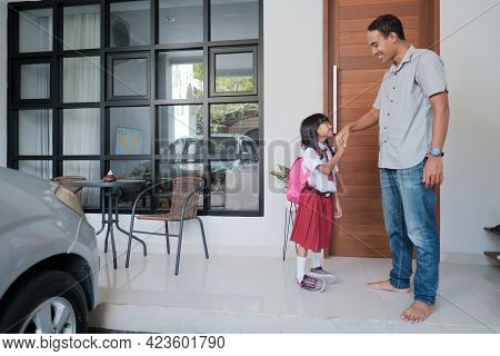 Indonesian Primary School Female Student Shake And Kiss Her Fathers Hand Before Going To School