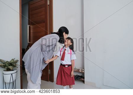 Mother Kiss Her Kid Cheek In The Morning At Home Before School Day