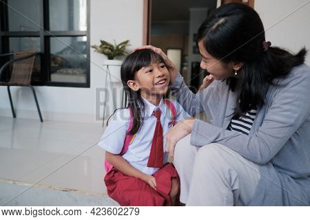 Happy Primary Student At Back Home After School And Talk