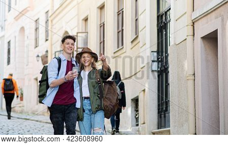 Young Couple Travelers Using Smartphone In City On Holiday, Sightseeing.