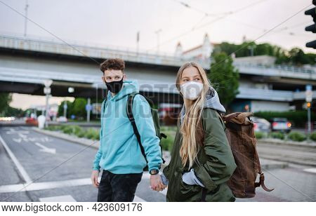 Happy Young Couple Travelers Sightseeing In City On Holiday, Coronavirus Concept.