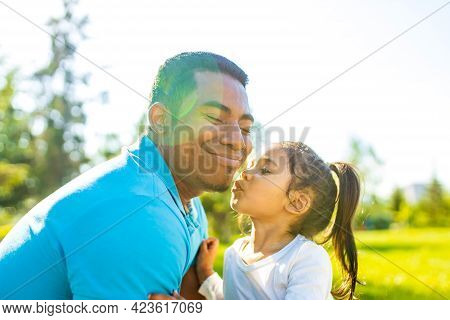 Latin Hispanic Man With Cute Baby Celebrating Fathers Day At Picnic In Sunny Park