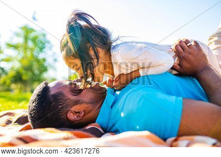 Latin Hispanic Man With Cute Baby Celebrating Fathers Day At Picnic In Sunny Park