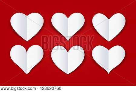 Cutout Paper Folded Hearts. White Papers Cut Fold Heart Shapes On Cardboard Red Burgundy Background 