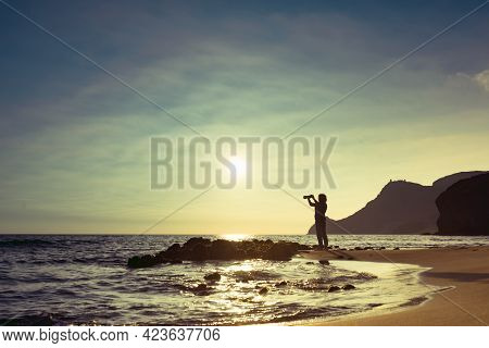 Tourist Woman With Camera Taking Travel Picture On Monsul Beach. Cabo De Gata Nijar Natural Park, Pr