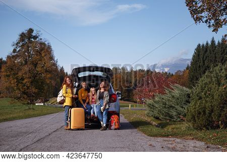 Big Family Trip - Happy Girls Travel By Car. Mamma With Daughters Sitting In The Boot