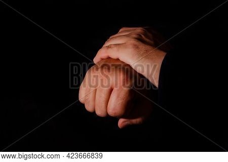 One Hand Gripping The Other Tightly To Ease The Pain. Post Covid Syndrome Concept.