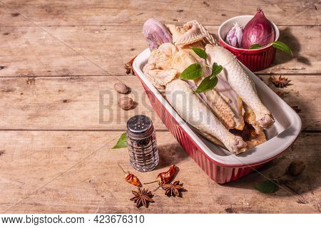 Raw Whole Chicken Carcass For Healthy Food Lifestyle With Traditional Chinese Spices In Ceramic Baki