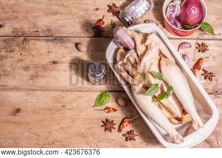 Raw Whole Chicken Carcass For Healthy Food Lifestyle With Traditional Chinese Spices In Ceramic Baki