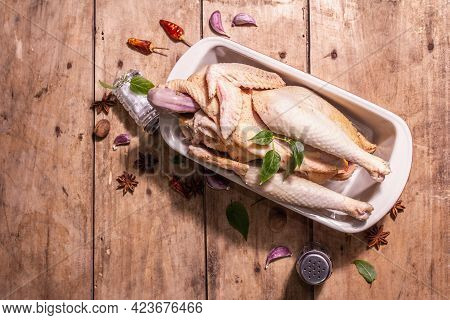 Raw Whole Chicken Carcass For Healthy Food Lifestyle With Traditional Chinese Spices In Ceramic Baki