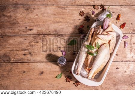 Raw Whole Chicken Carcass For Healthy Food Lifestyle With Traditional Chinese Spices In Ceramic Baki