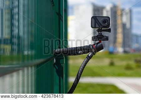 Compact Action Camera On A Flexible Tripod. Outdoor Travel Equipment.