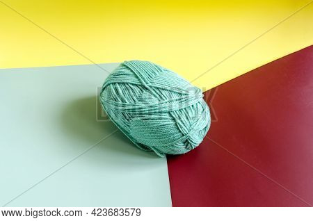 A Skein Of Green Yarn On A Colored Background Close Up Knitting In Self Isolation