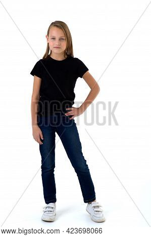 Pretty Blonde In A Black T-shirt. Girl In Fashionable Clothes Posing In The Studio. Full-length Port
