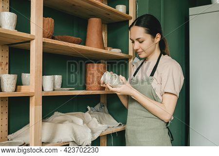 The Potter Woman Checks The Finished Ceramic Dishes. The Concept Of Small Business And Creativity