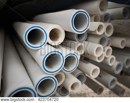 Polypropylene Pipes Stacked At Construction Site. Stack Of Ldpe Water Pipes. Pvc Pipes