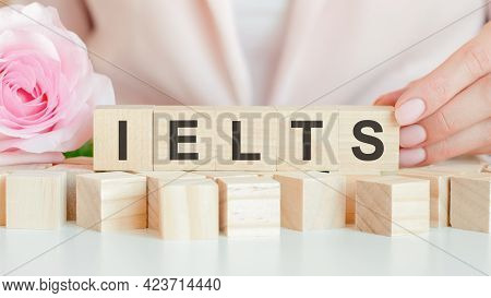 Ielts Text On Wooden Block In Hand, Concept