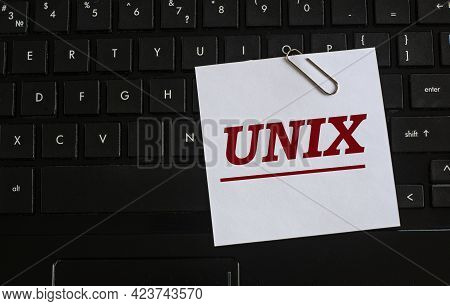 Unix - Word On A White Sheet Against The Background Of The Laptop Keyboard. Internet Concept