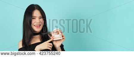Woman Holding Toothbrush And Dental Teeth Model. Oral Health Care Concept.
