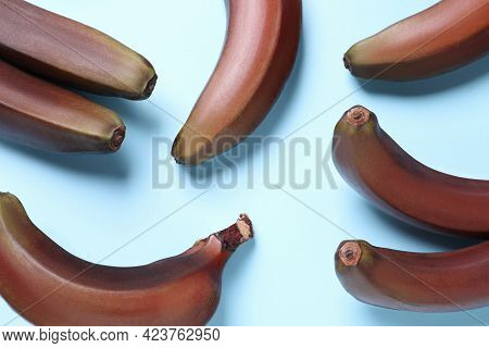 Tasty Red Baby Bananas On Light Blue Background, Flat Lay