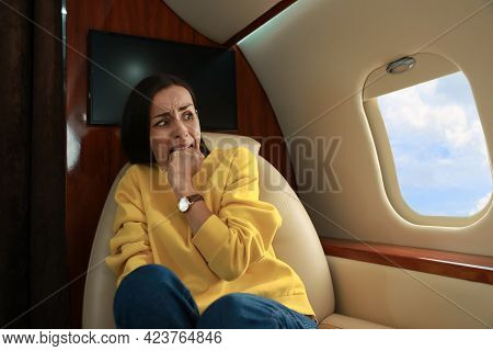 Nervous Young Woman Suffering From Aviophobia In Airplane
