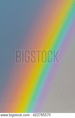 Closeup Of Intense And Vibrant Rainbow In Gray Sky. Meteorology, Weather And Symbolism Concepts