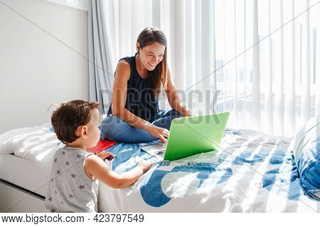 Work From Home With Kids. Busy Mother Working On Laptop With Baby Boy Toddler At Home. Remote Work, 