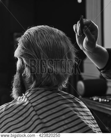 Guy With Long Dyed Blond Hair Close Up. Do Not Cut Your Own Hair. Barber Works On Hairstyle For Bear
