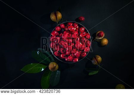 Nutmeg Seeds In Round Pot And Nutmeg Fruits Green Leaf , Nutmeg Fruits And Seeds On Dark Background,