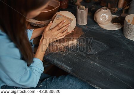 Beautiful Ceramicist In Uniform Modeling Tableware In Pottery Workshop