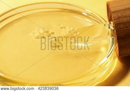 Pipette With Wooden Zer Waste Cover Lies In The Petri Dish With Oil.cosmetics Research Concept.brigh