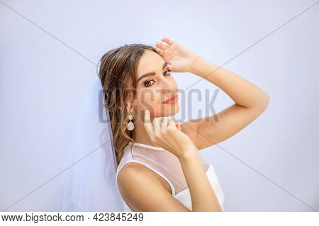 Brunette Girl In A Wedding Dress. Bride In A White Dress. Makeup.