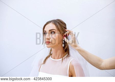 Brunette Girl In A Wedding Dress Bride In A White Dress. Makeup.