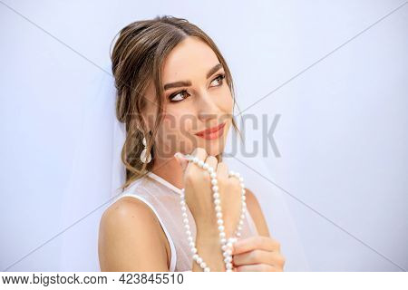 Brunette Girl In A Wedding Dress. Bride In A White Dress. Makeup.