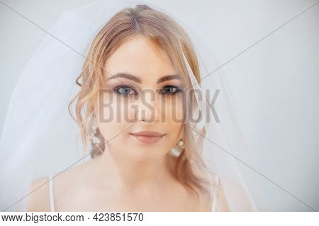 Blonde Girl In A Wedding Dress Bride In A White Dress. Makeup.