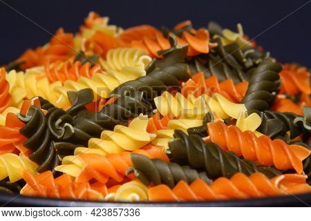Three Colors Rotini Pasta. Pasta Fusilli Tricolore Background. Abstract Texture Of Colorful Pasta. P